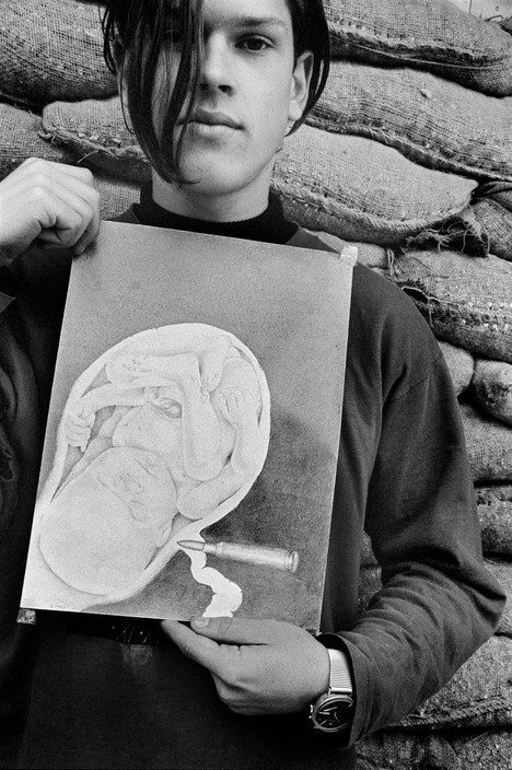 At the School of Art in Dobrinja, a teenager shows a drawing he made in class. Sarajevo. 1993.