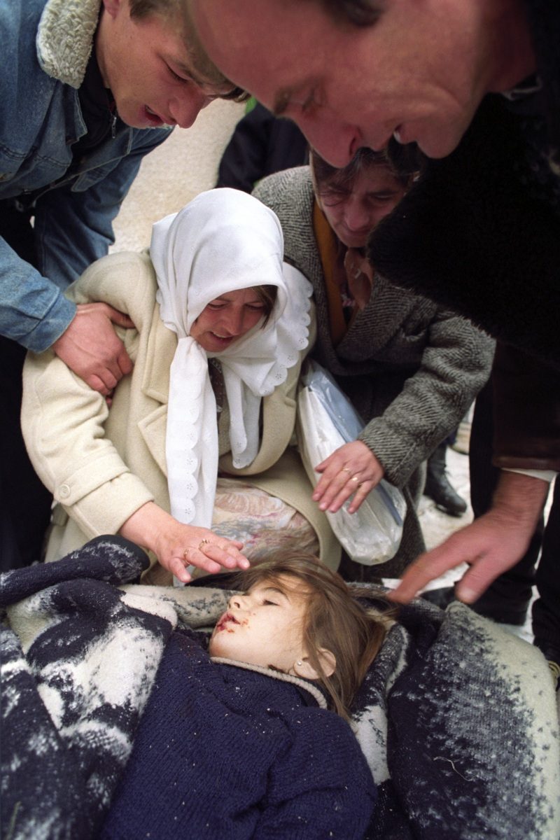 I only learned her name, Emina, and age, six, after she died. I first spotted her while I was walking up a hill to get into an area in Sarajevo that had come under heavy attack the night before. She and some of her friends were riding small wooden sleds down the hill, enjoying a quiet, sunny but cold winter morning. I passed the girls and was touched by how children can cope with war, how they can forget it for a few moments and pretend life is normal as they run and sled and play. When I was on top of the hill, a shell landed where the children were playing in the snow, and I ran down to see what happened. There was Emina lying next to her sled; shrapnel had hit her on the neck and cut the main artery. At this moment, she still looked alive. Sarajevo, Bosnia And Herzegovina, January 1993. EPA/ANJA NIEDRINGHAUS