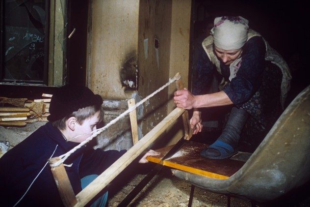 A woman and her son saw the table to use it as firewood, Sarajevo, Bosnia And Herzegovina, 23 January 1993. EPA/ANJA NIEDRINGHAUS