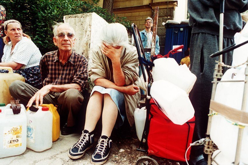 A woman bursts into tears at a water dispenser in Sarajevo when, after waiting for hours, she learns that there is no drinking water. 1995. EPA/ANJA NIEDRINGHAUS