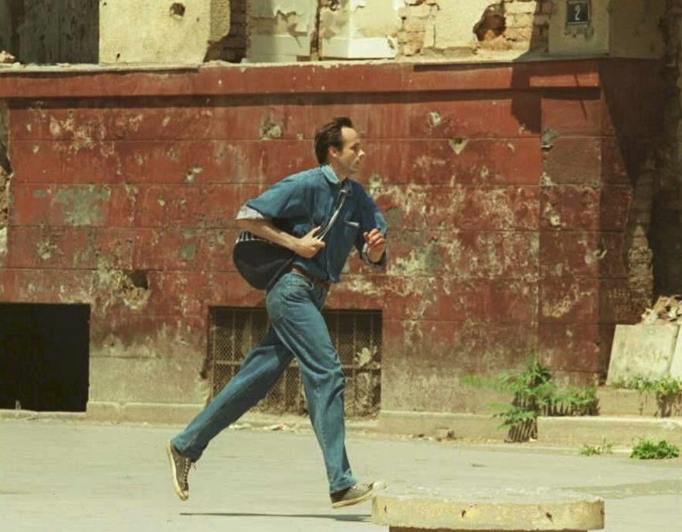 A man runs across the street as shells slam into the Bosnian capital. EPA/ANJA NIEDRINGHAUS