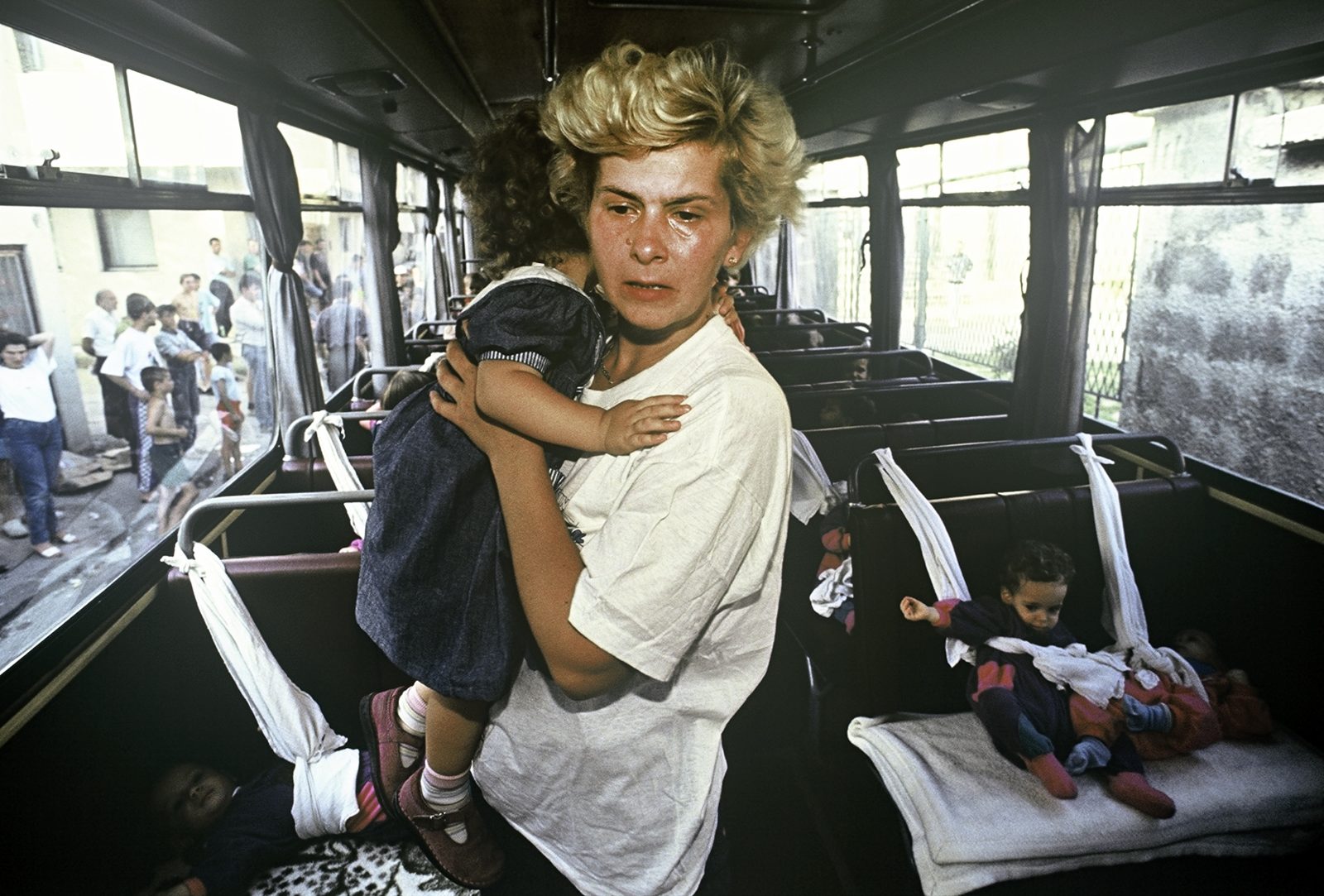 The bus that is supposed to evacuate 54 children from the besieged Sarajevo is ready. Caregivers bring the frightened children onto the bus. Bosnia and Herzegovina, Sarajevo 01.08.1992
