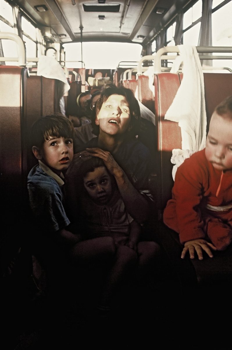 After the bus is shot at by the Serb forces a caregiver is looking for cover and pushes down a girl's head with her hands. Bosnia and Herzegovina, Sarajevo 01.08.1992