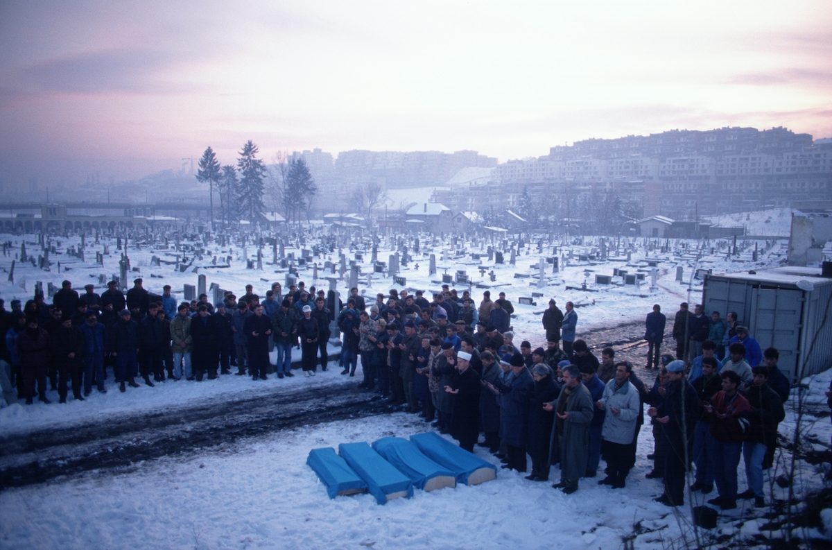 People gather at Lion Cemetery for the funeral of four children, killed the previous day by mortar fire while playing near their apartment building in Sarajevo, Bosnia and Herzegovina, 25 January 1994