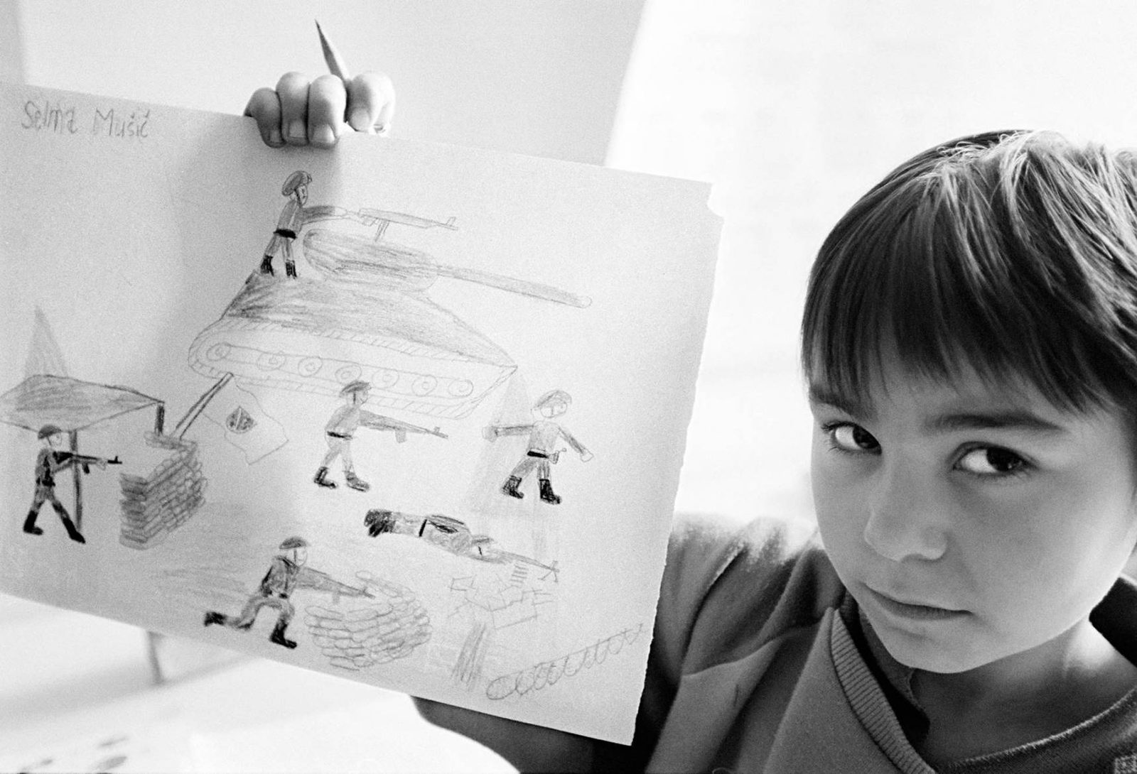 Children at a primary school in Mostar, displaying their drawings depicting scenes of war. 8November 1995.
