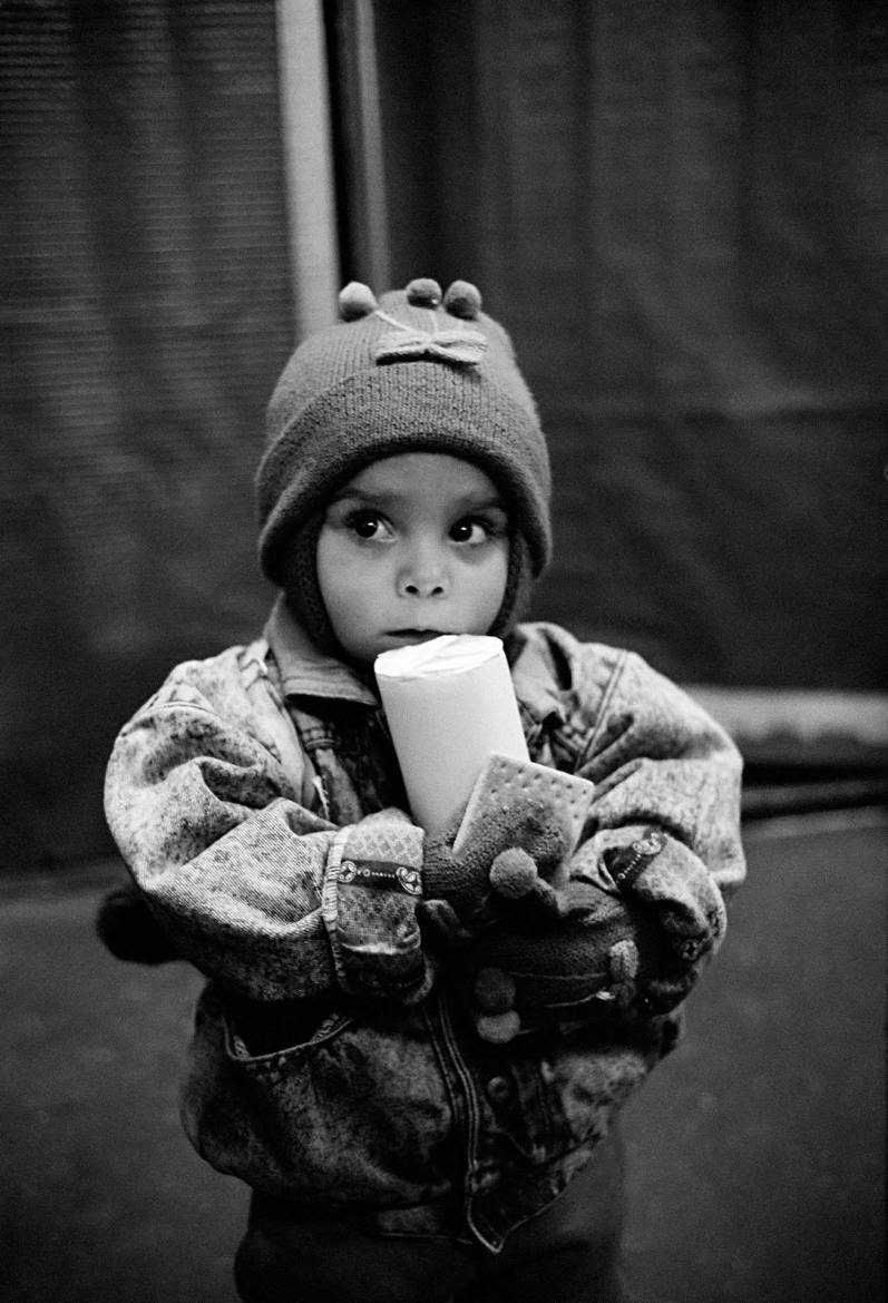 A child collecting high protein biscuits at the UNICEF supplementary feeding centre in Sarajevo, 10 November 1995.