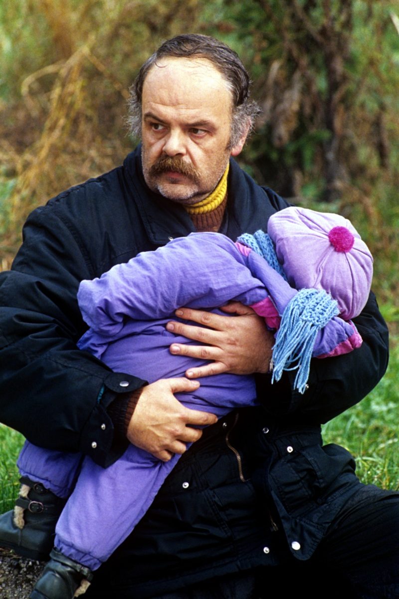 A Bosnian father holds his child before evacuating him out from Sarajevo, 25 November 1992. EPA | DIMITRI MESSINIS