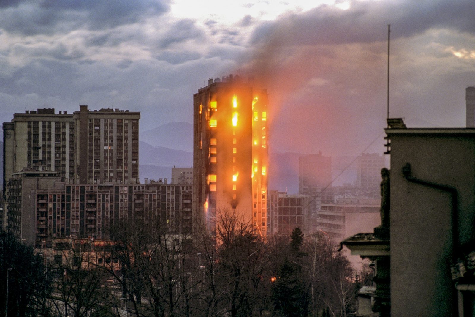 The building burns after Serbian shelling in Sarajevo, 5 December 1992. EPA | DIMITRI MESSINIS