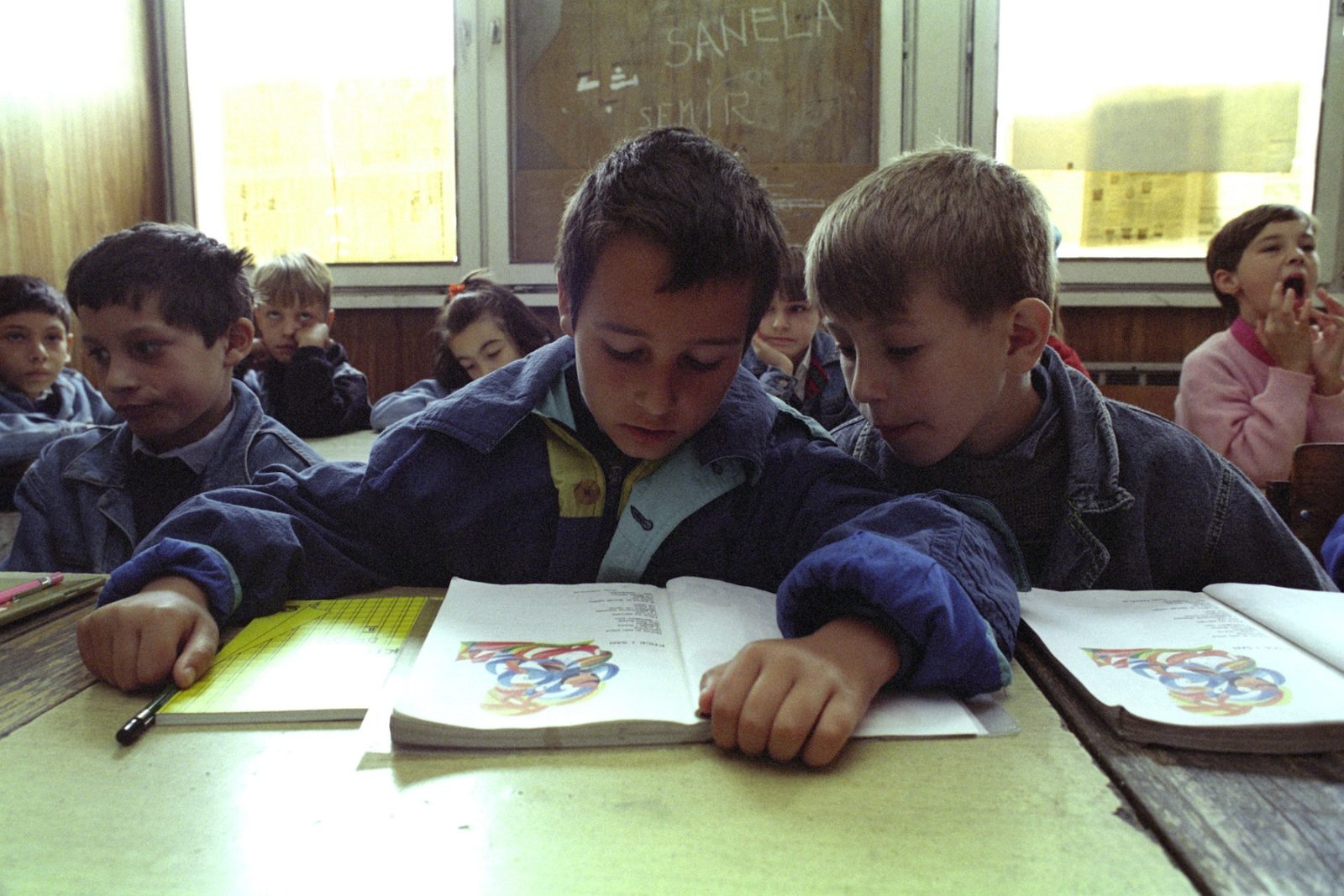 A group of schoolboys settle down for a school lesson in Sarajevo, Bosnia and Hercegovina, 6 September 1993.