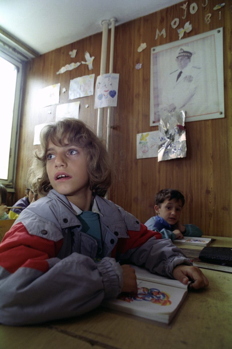 A group of schoolboys settle down for a school lesson in Sarajevo, Bosnia and Hercegovina, 6 September 1993.