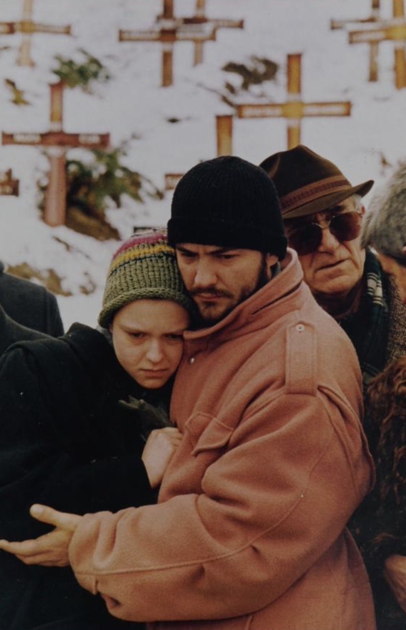 A brother and sister mourn over the grave of their father during funeral services in the snow covered Lion cemetery in Sarajevo on 26 January 1993. Their father was killed during shelling of Sarajevo by Serb forces.