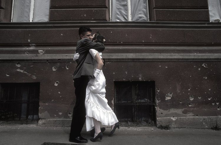 Love endures. During a lull in the siege of Sarajevo a couple embrace just after being married. 1995