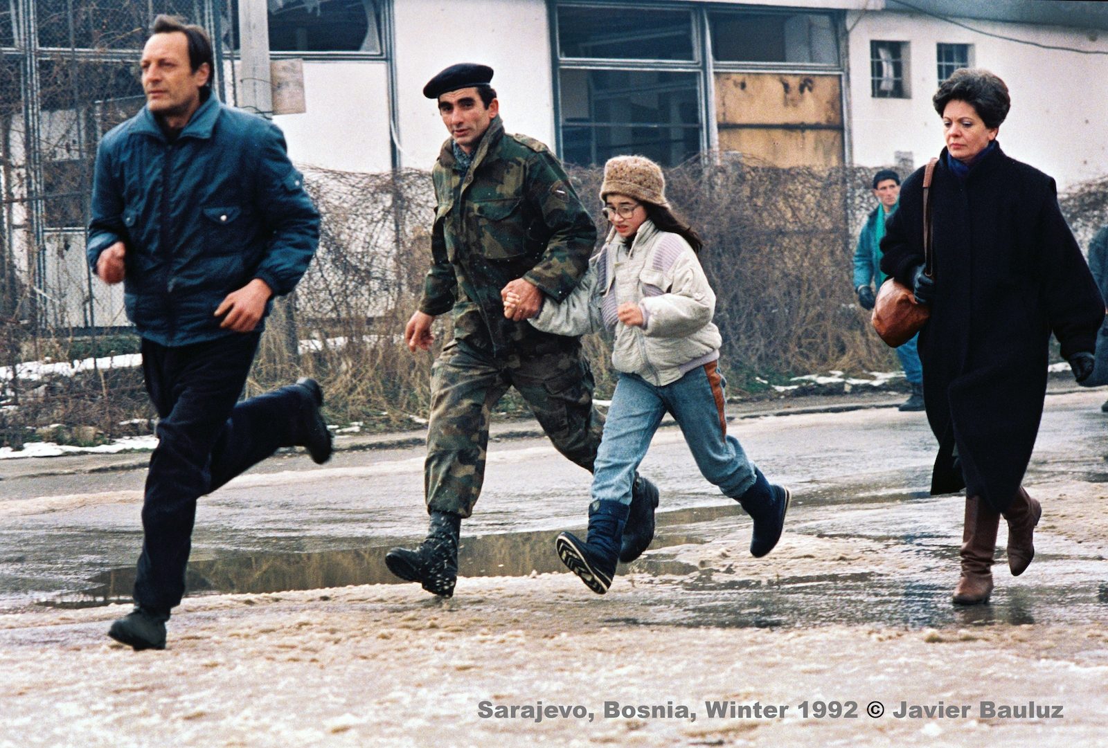 Bosnian soldier father runs with daughter to avoid being killed by Serb snipers. Sarajevo Bosnia and Herzegovina, Winter 1992.