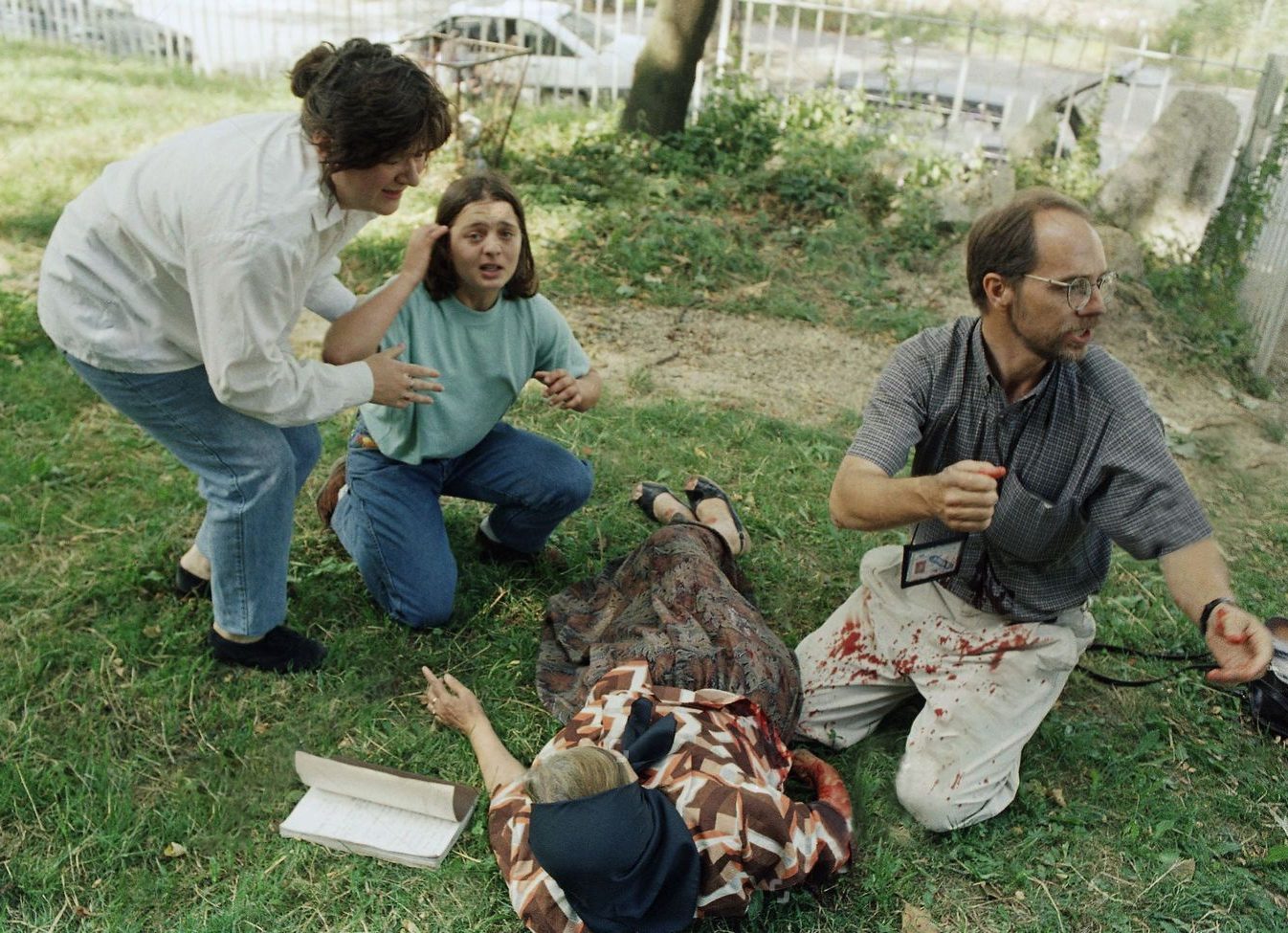 Ruza Glaves grandmother of one of the two children killed by snipers as they were being evacuated on Saturday, receives medical attention as she lies wounded in the Lions cemetery in Sarajevo, on five members fell during the funeral of the two children and the grandmother was rushed to the local hospital by foreign press covering the event.