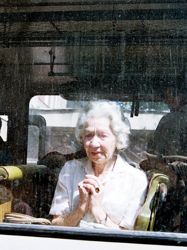 SARAJEVO, BOSNIA, 18 AUGUST 1993 -- Bosnian Jew Ljerka Danon, an Auschwitz survivor, prays through a bus window in the besieged Bosnian capital. Danon, along with 60 other Bosnian Jews were evacuated to Croatia as part of a humanitarian gesture organized by the United Nations. © Photo Credit: Mark H. Milstein/ Northfoto