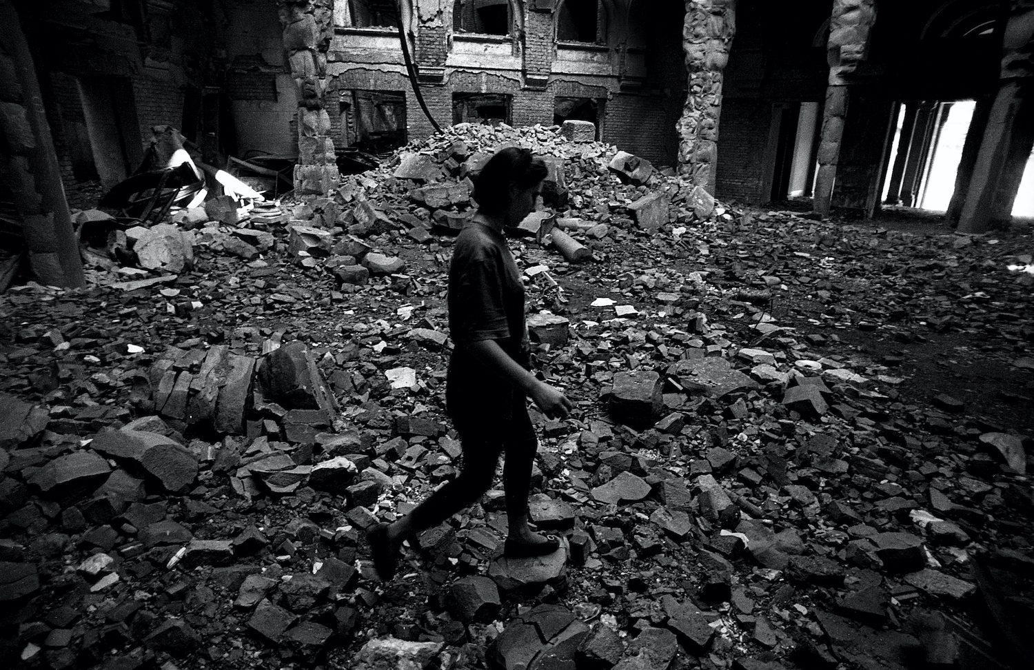 A girl inside the Sarajevo library destroyed by the Serbs in 1992. Sarajevo, Bosnia and Herzegovina, August 1993