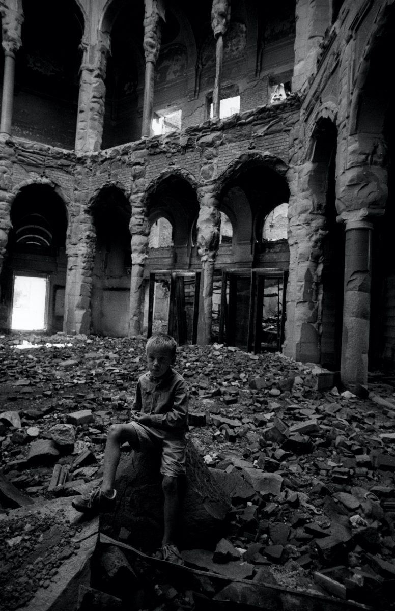 A boy inside the Sarajevo library destroyed by the Serbs in 1992. Sarajevo, Bosnia and Herzegovina, August 1993