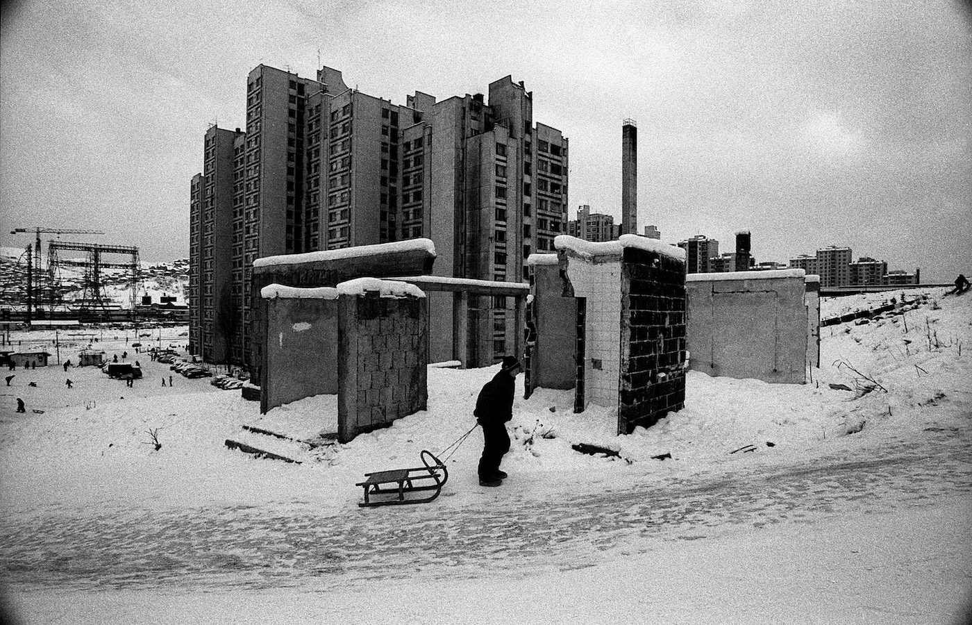 A boy with his sled during in the western part of Sarajevo. Sarajevo, Bosnia and Herzegovina, December 1994