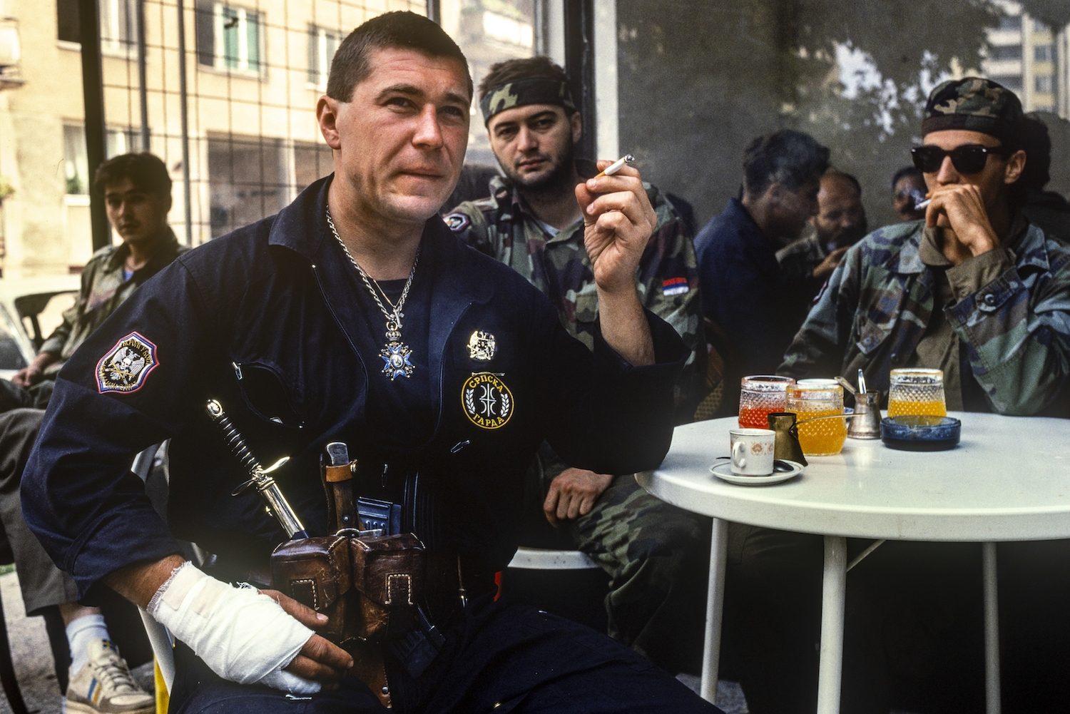 Bosnian Serb special forces soldiers drinking coffee in a street cafe in the Serb controlled area of Gabivica, Saravejo, September 1992g