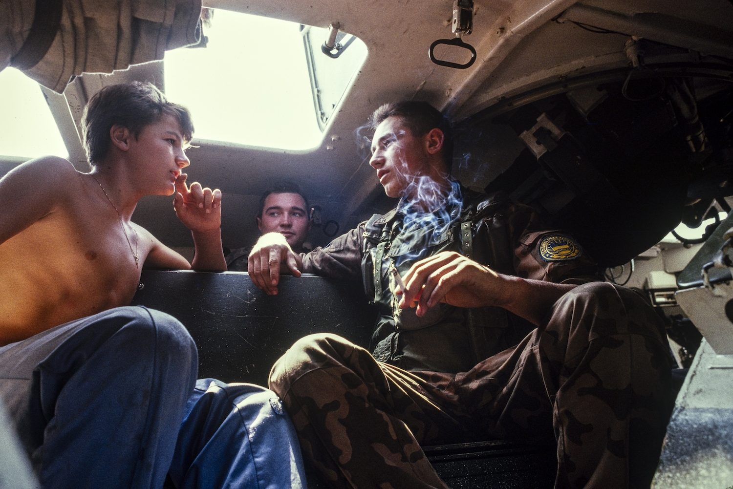 Russian UN troops show off their APC to a Serb farm boy near Lukavica barracks, Saravejo, September 1992