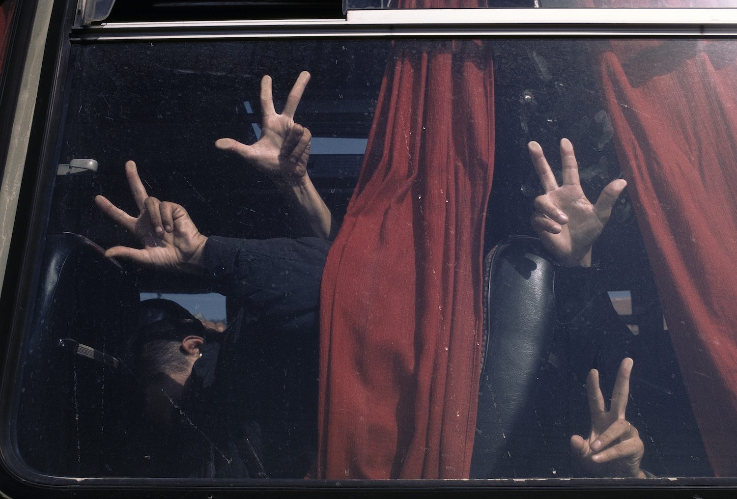 Serb soldiers humiliate Muslim prisoners from Manjaca concentration camp by forcing them to give the Serb salute. The prisoners are in transit to Knin for a prisoner exchange attempt that failed, Serbian Krijina, September 1992.