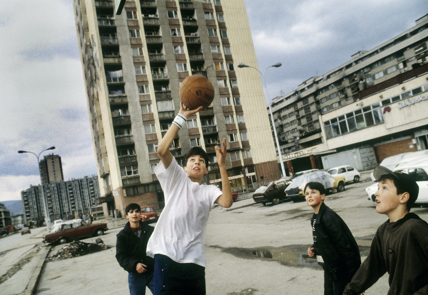 Young boys playing basketball in a carpark. Bosnia and Herzegovina, Sarajevo.