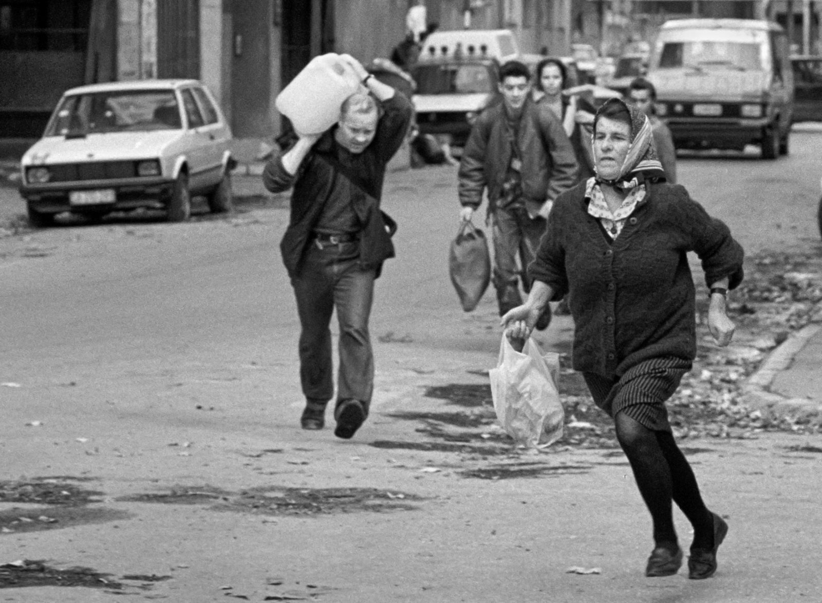 Bosnian civilians run across Sarajevo's notoriously dangerous 'Sniper Alley' on November 29, 1992.
