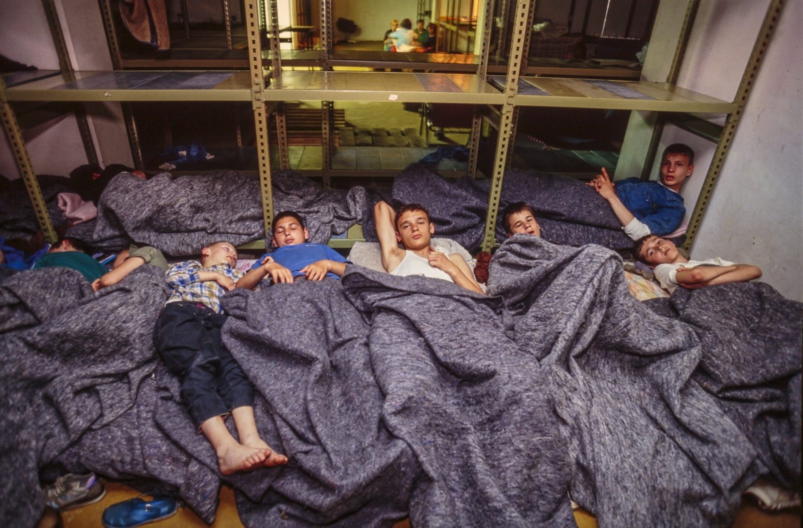 A Bosnian refugee family sleeps in an underground basement, sheltered from bombardments. 03 Aug 1992, Sarajevo, Bosnia and Herzegovina