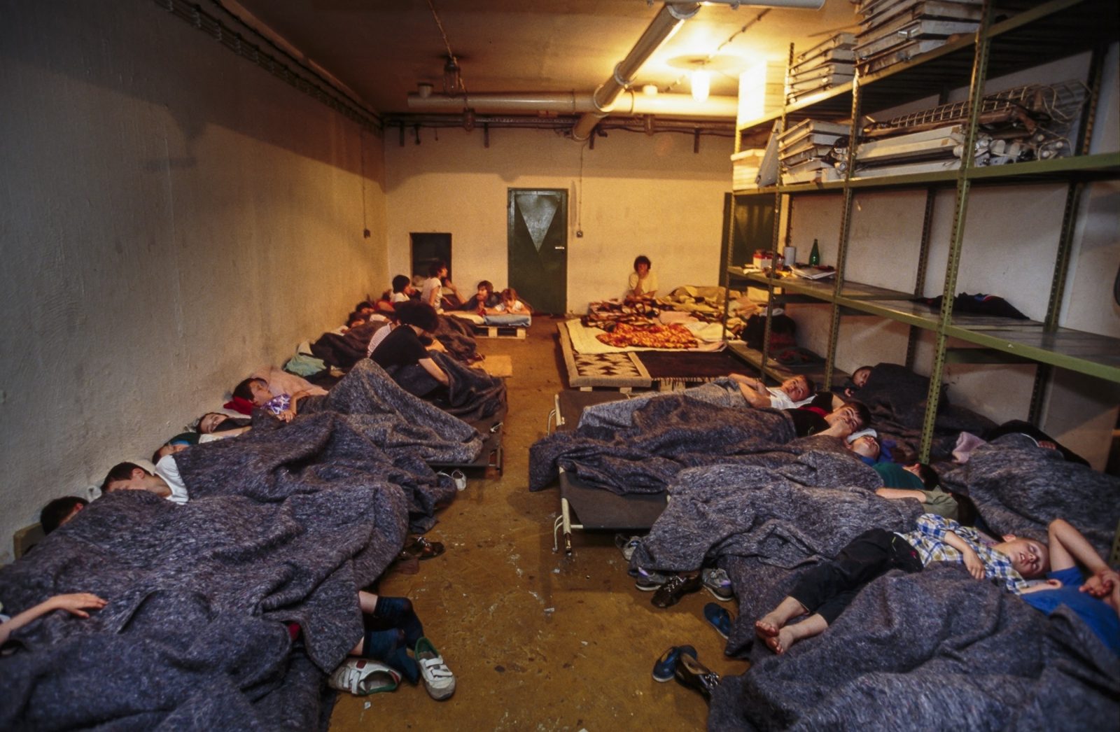 A Bosnian refugee family sleeps in an underground basement, sheltered from bombardments. 03 Aug 1992, Sarajevo, Bosnia and Herzegovina