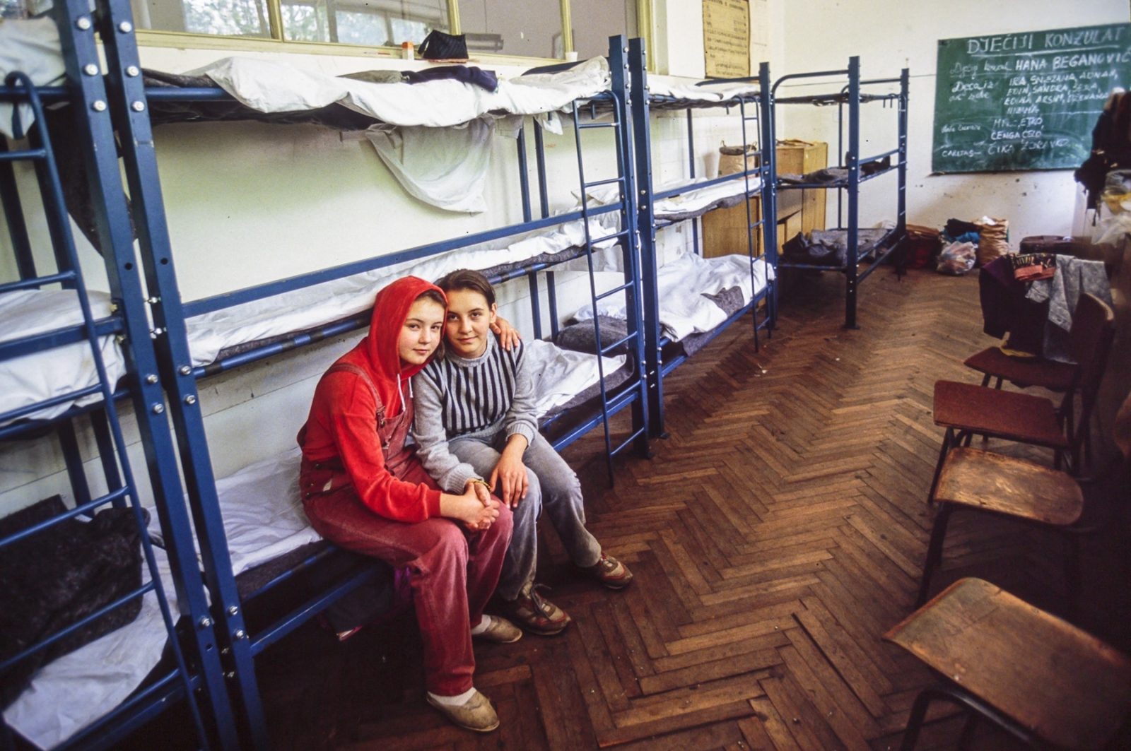 Young Bosnian refugees sleep on cots in a room of an old school. 13 Jul 1992, Sarajevo, Bosnia and Herzegovina
