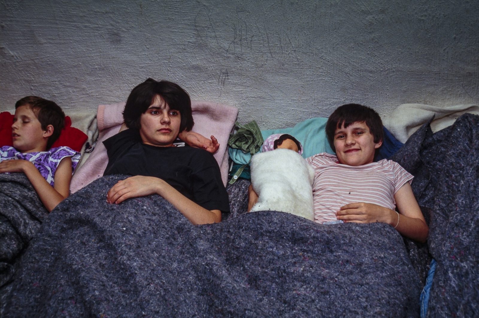 A Bosnian refugee family sleeps in an underground basement, sheltered from bombardments. 03 Aug 1992, Sarajevo, Bosnia and Herzegovina