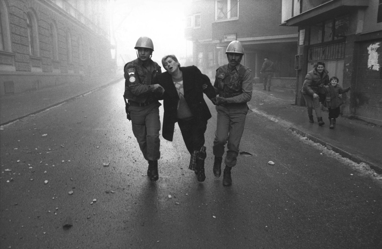 United Nations peacekeeping soldiers from Egypt help an injured woman running from the scene of an explosion in the city centre.