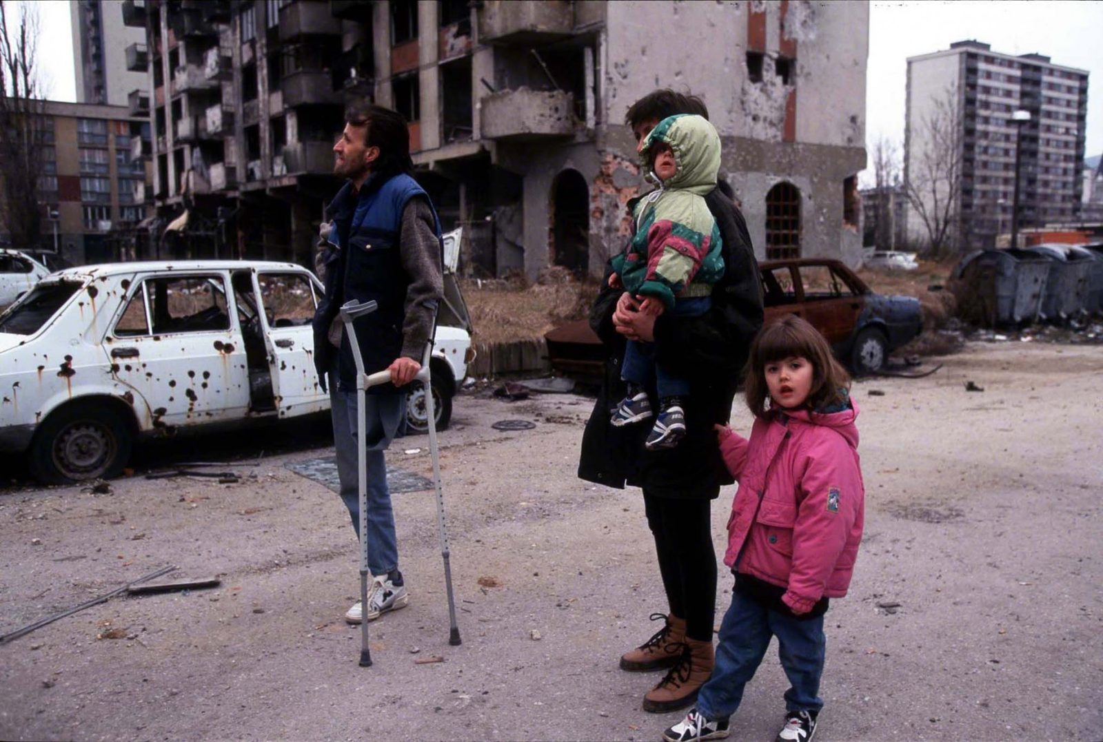 A Grbavica resident family walks through the streets of their destroyed neighborhood. Sarajevo. Photo Copyright © Peter Kullmann| Zone5 | fullframeRAW