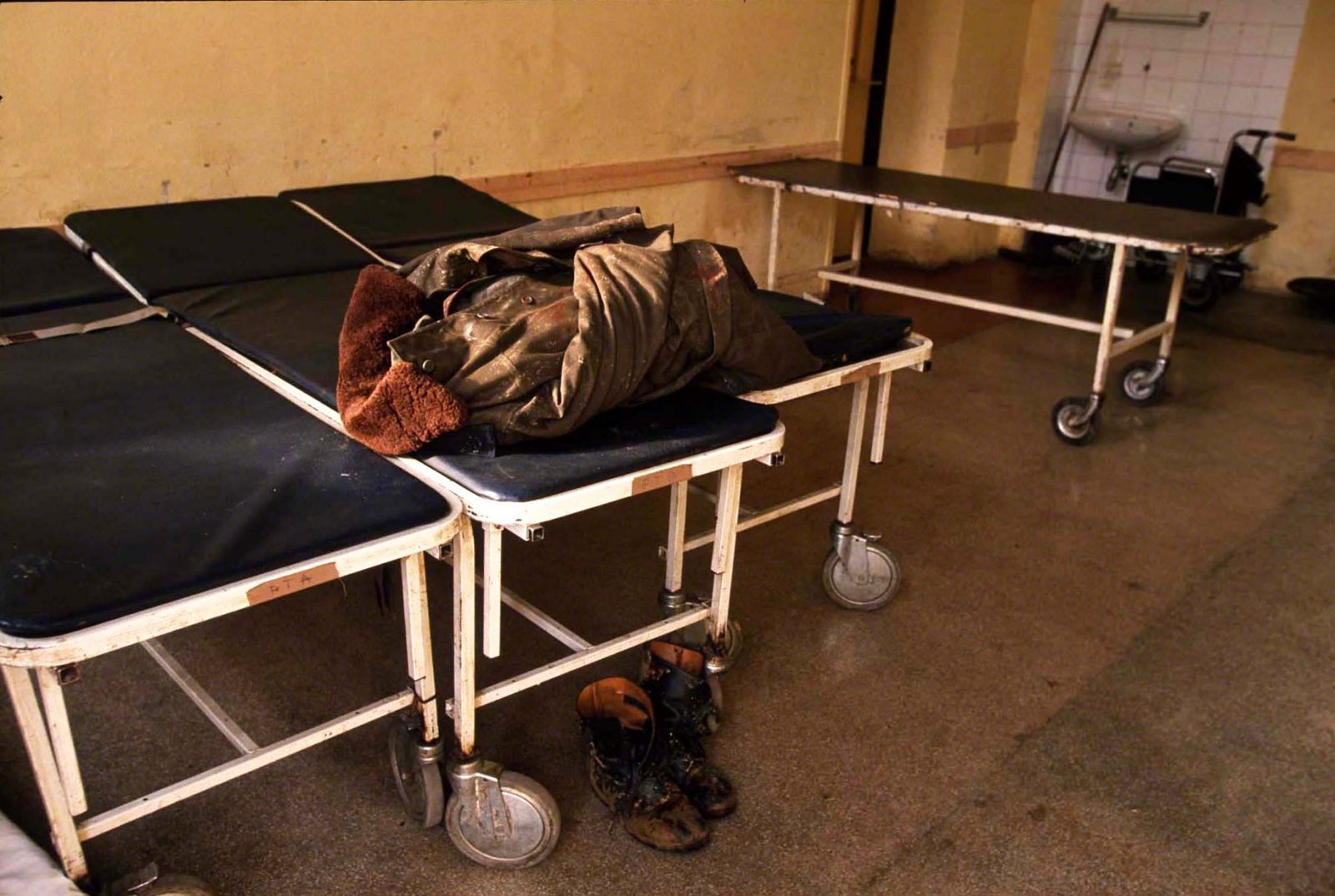 Clothing of a deceased military man lying on a hospital stretcher in Kosevo Hospital. Sarajevo, January 1993. Photo Copyright © Peter Kullmann| Zone5 | fullframeRAW