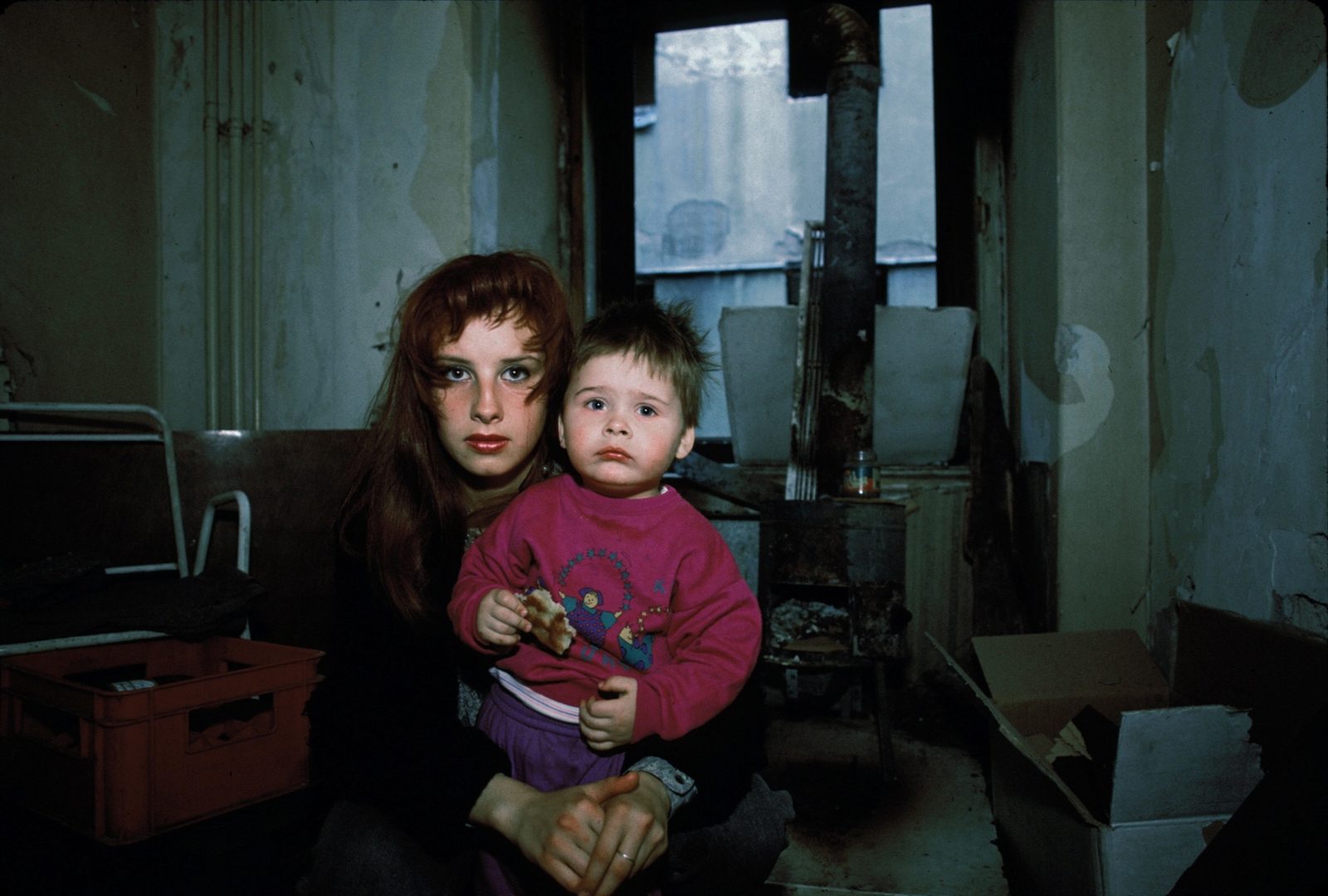 A young Bosnian woman and her little brother, both refugees from a village ethnically cleansed by the Bosnian Serbs outside Sarajevo, photographed in a gutted room of the abandoned Hotel Europa in downtown Sarajevo during the siege, September, 1993.