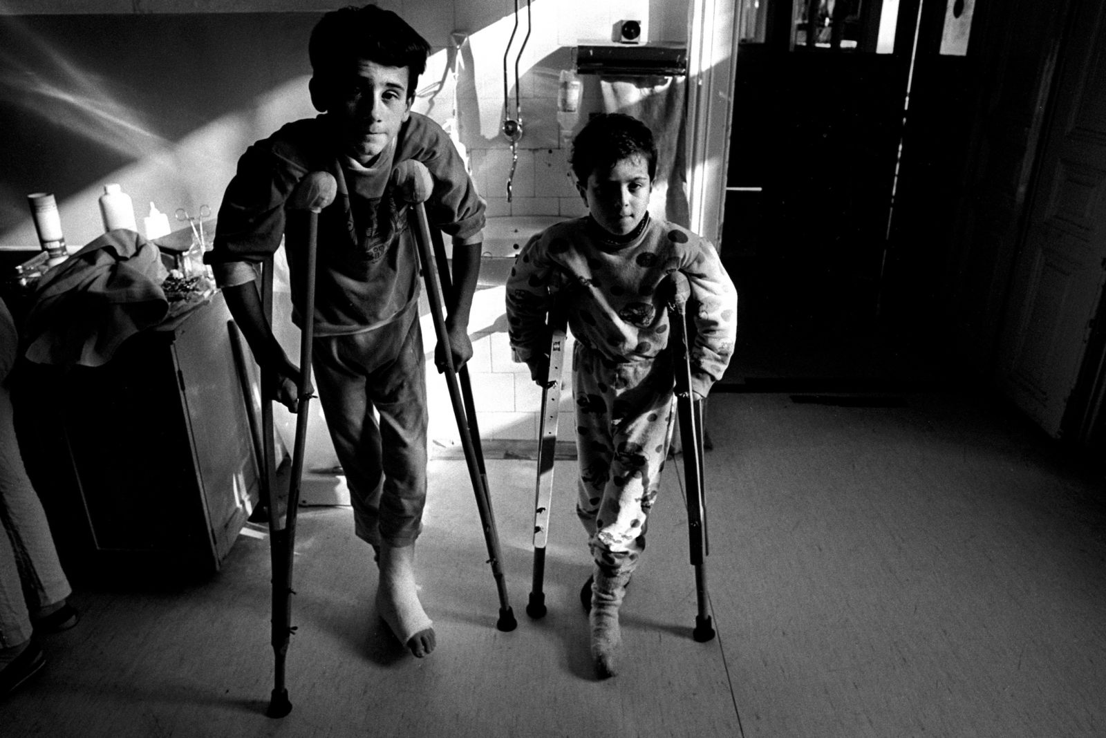 Two young boys recovering from shrapnel wounds caused by Serb shells, Kosevo hospital, Sarajevo, Bosnia-Herzegovina, February 1993.