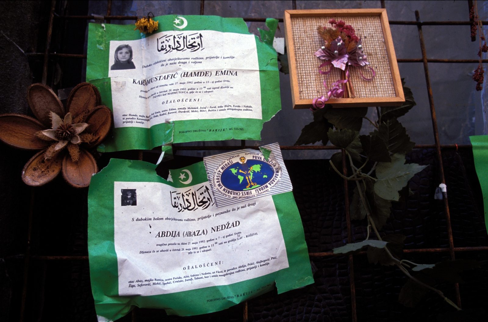 Death notices posted on a downtown wall for two children, Emina Karamustafic, 13, and Nedzad Abdija, 7, who were killed in the infamous Bread Line Massacre on 27th May, 1992. A pair of mortar shells launched by Bosnian Serb forces struck outside a bakery where civilians were lined up for bread during the siege of Sarajevo, 1992. An estimated 1600 children were killed in Sarajevo during the 3-1/2 year siege.