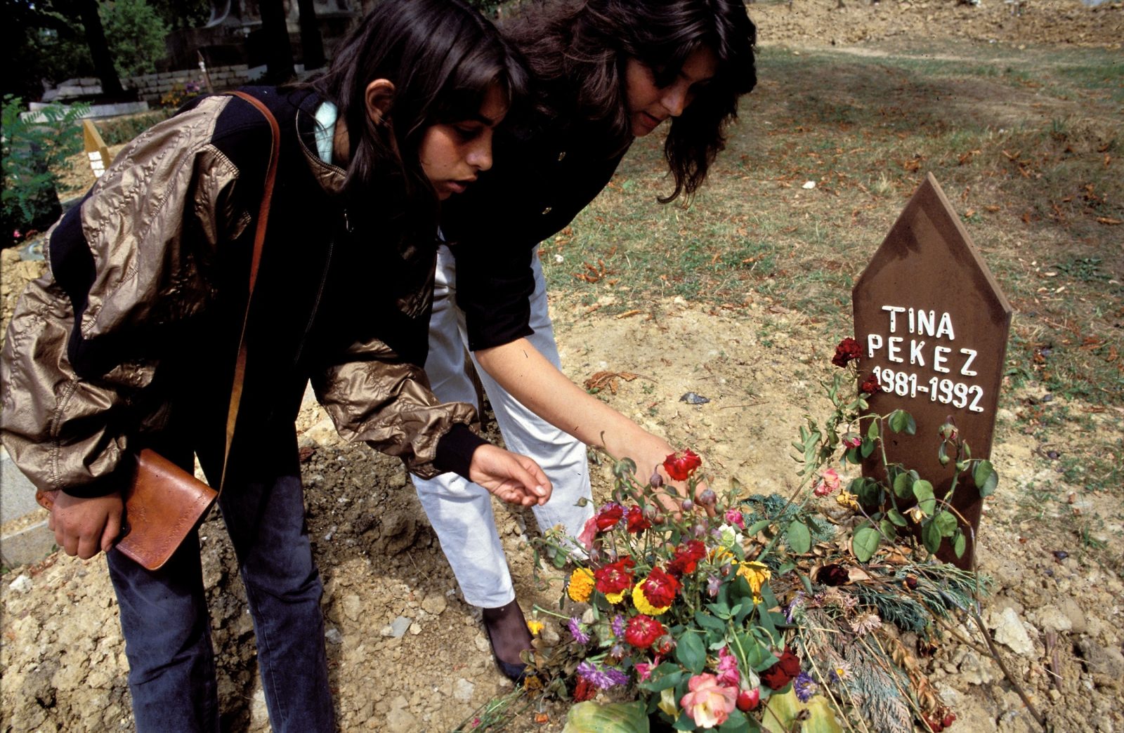 Visitors place flowers on the grave of 11-year-old Tina Pekez, who was killed in the Bosnian Serb siege of Sarajevo, September, 1992. 1601 children were killed in Sarajevo during the 3-1/2 year siege.