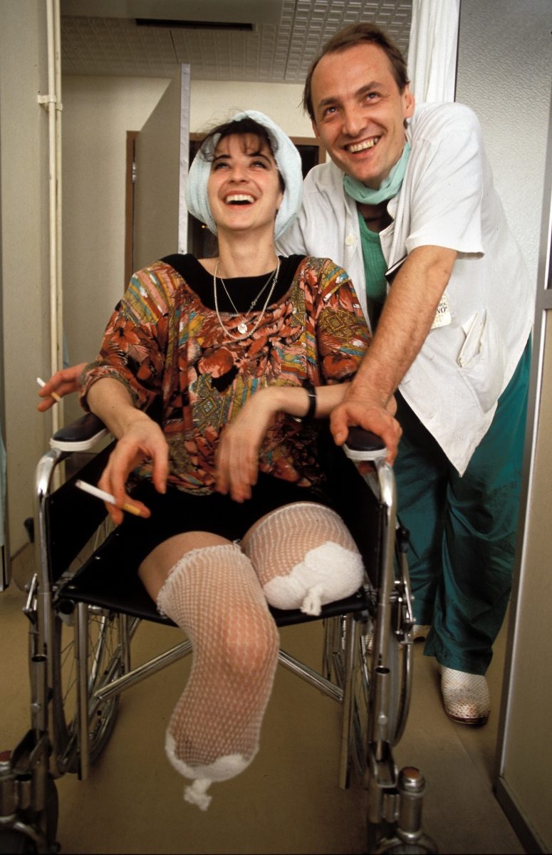 Fikreta Hadovic, 24, who lost both her legs to a Bosnian Serb shell, poses for a photograph with Dr. Edib Jaganjac at French Hospital in Sarajevo, August 1992.