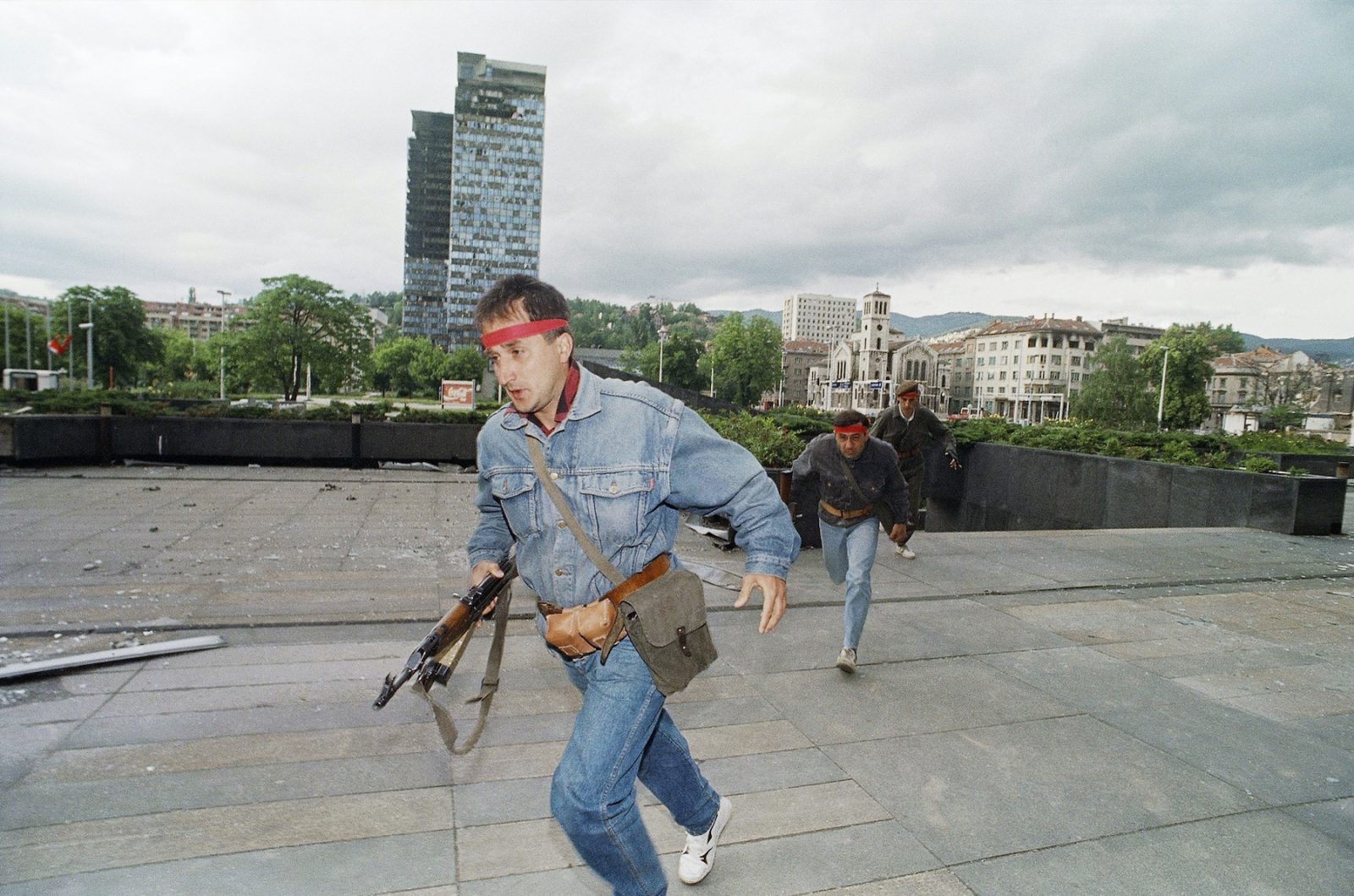 Bosnian fighters run towards one of their positions after a battle erupted near the city center for control of a strategic hill, Friday, June 12, 1992 in Sarajevo. Serbian forces continue to besiege this city. Serbs on Friday announced a cease fire in Bosnia-Herzegovina beginning next week offering their fullest cooperation yet to U.N. monitors in the republic.