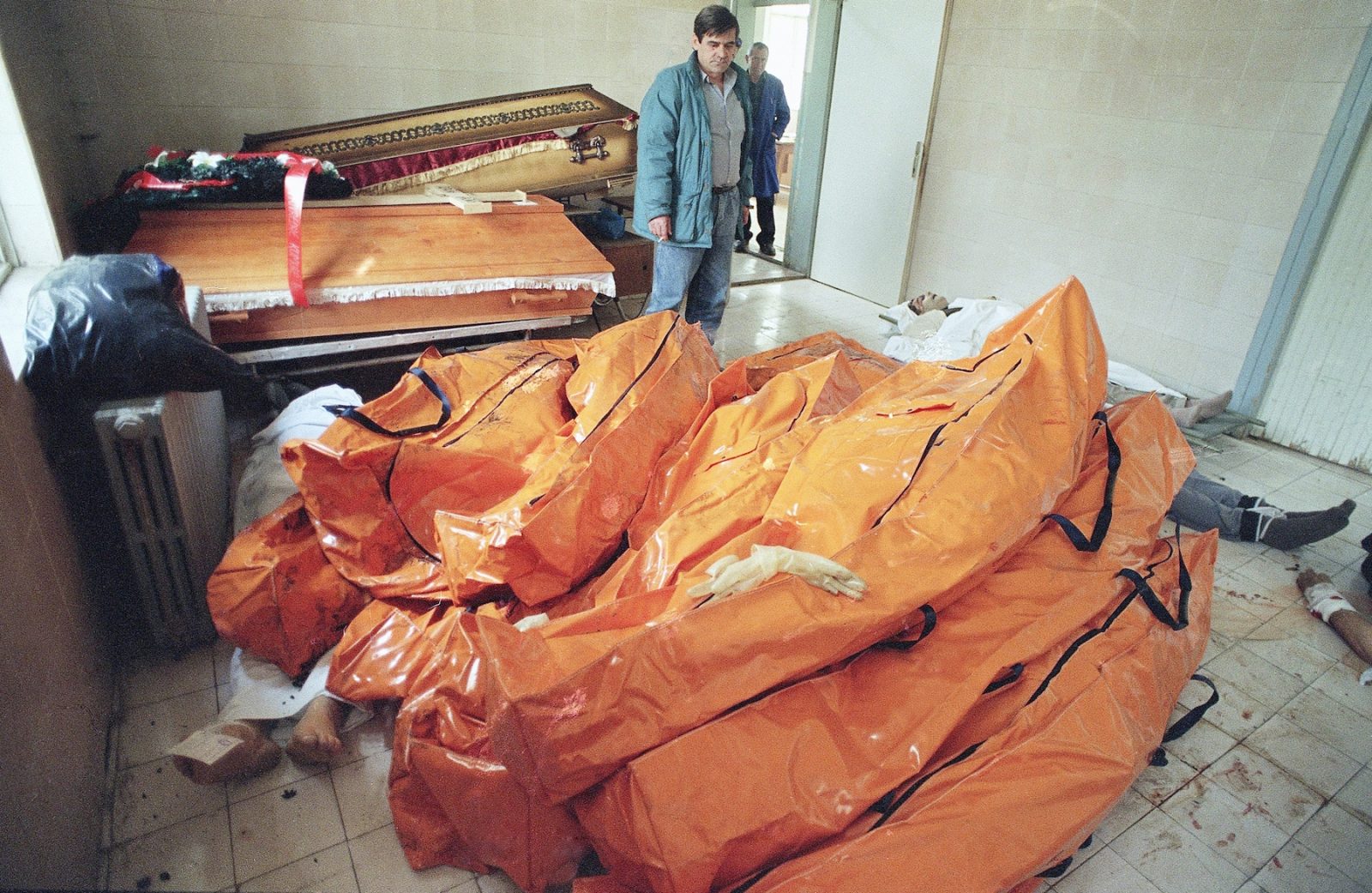 Body bags are stacked high in front of coffins in one of Sarajevo's morgue on Thursday, May 8, 1992 in Sarajevo. At least 80 bodies are waiting to be identified and be taken away. Serbs fought Bosnian in Sarajevo Friday, turning the sky orange with the fires of explosions.