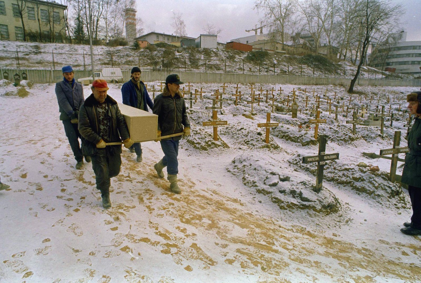 Grave diggers carry a coffin through the snowy Lion's cemetery in Sarajevo on Dec. 28, 1992.