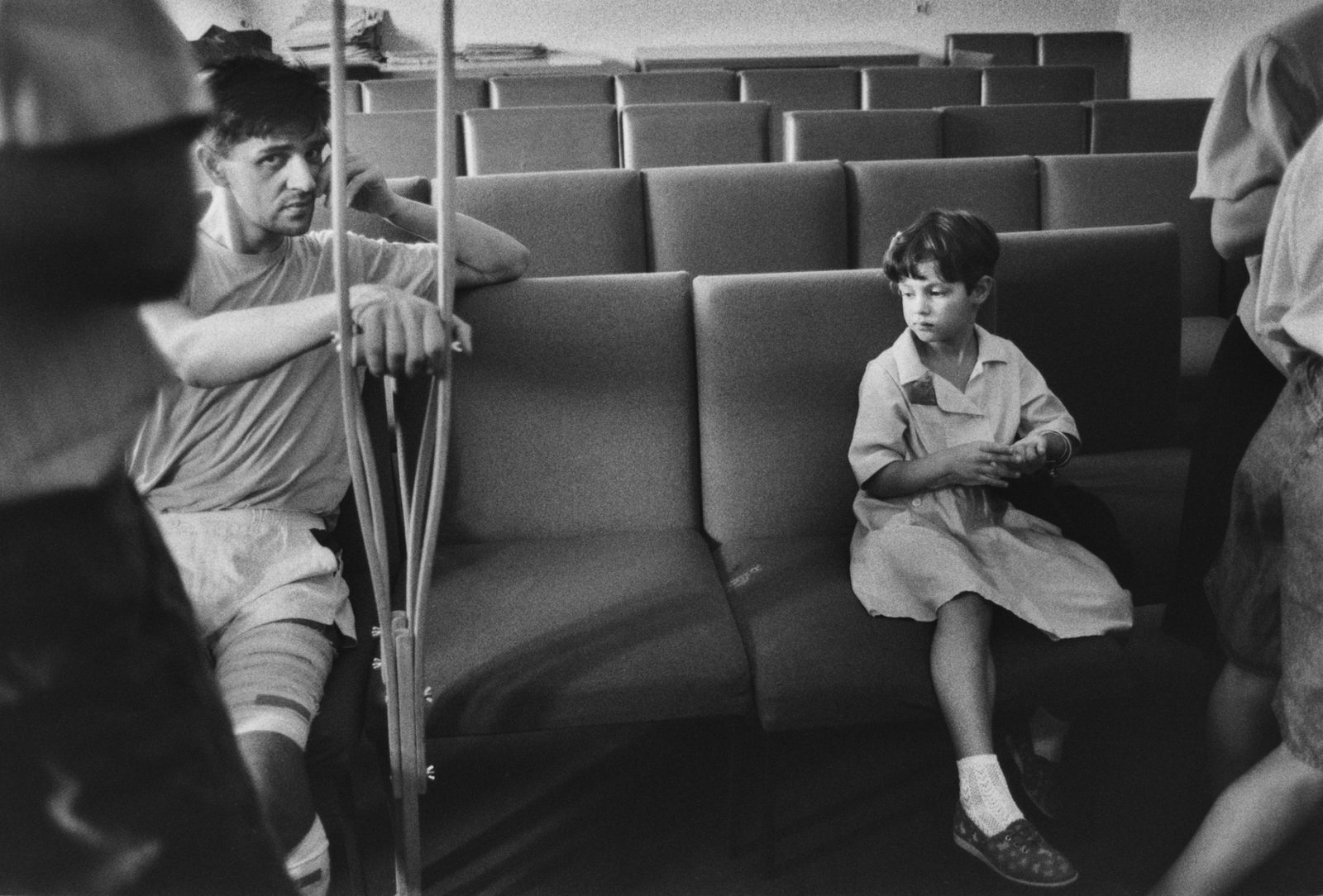 A young girl sits with an injured man diring a wedding service held in hospital during The Siege of Sarajevo, Bosnia and Herzegovina which lasted 1,425 days from April 5, 1992, to February 29, 1996.