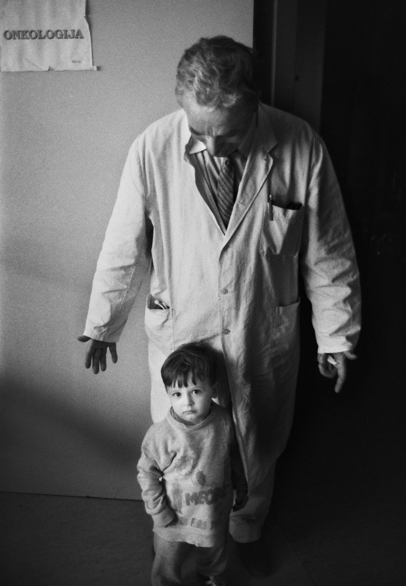 A doctor cares for a young boy in the Kosovo Hospital duing The Siege of Sarajevo, Bosnia and Herzegovina which lasted 1,425 days from April 5, 1992, to February 29, 1996,. It was the longest siege in modern European history.