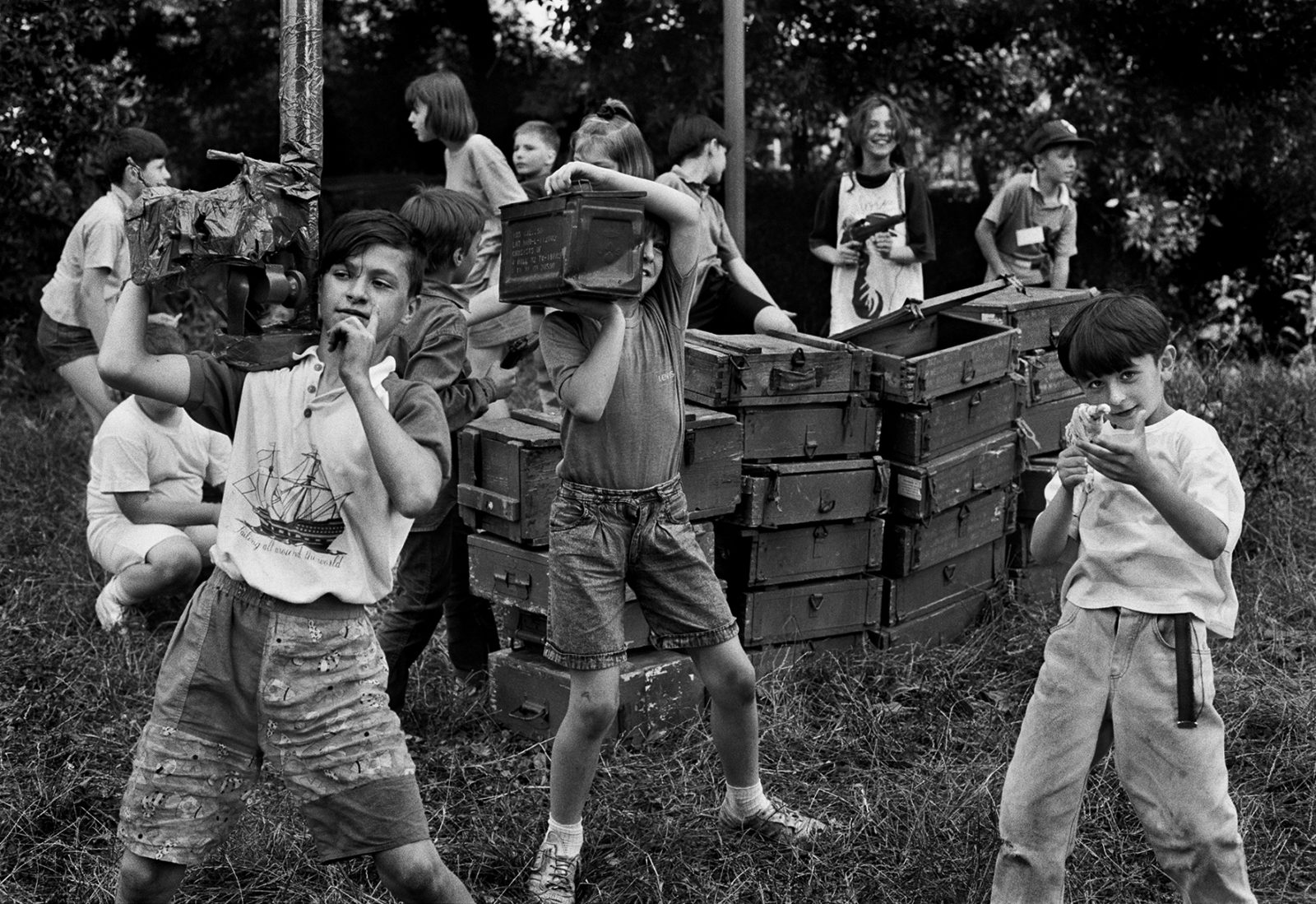 Children use empty ammunition boxes as they play Serb against Bosnians during a break in the real life shelling of Sarajevo of 1992. (Photo By Tom Stoddart/Getty Images)