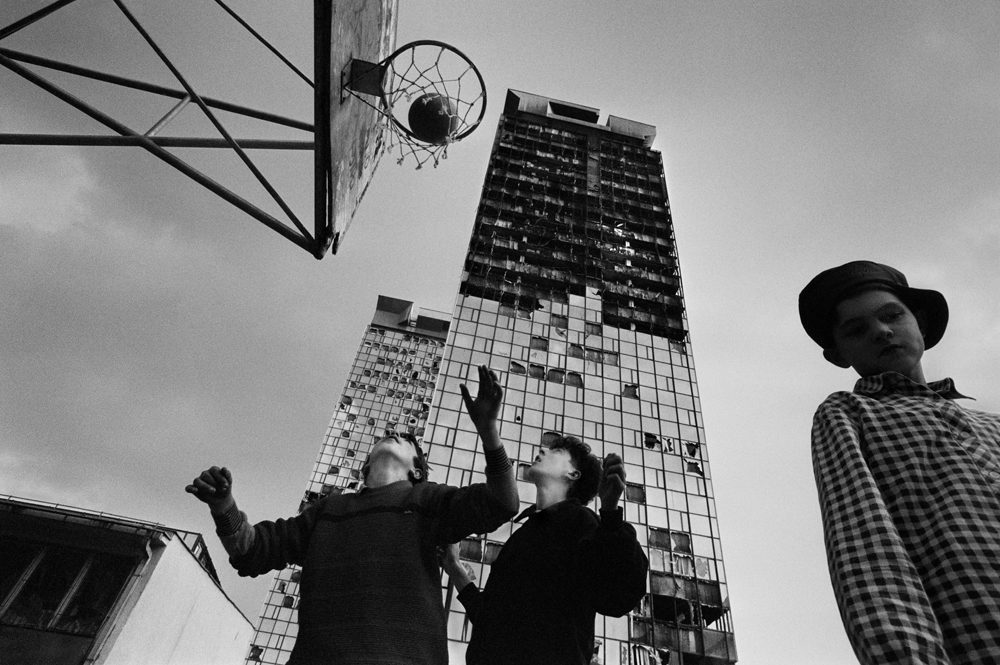 During a break in the shelling children play basketball in the burnt out financial district of Sarajevo in 1992. (Photo By Tom Stoddart/Getty Images)