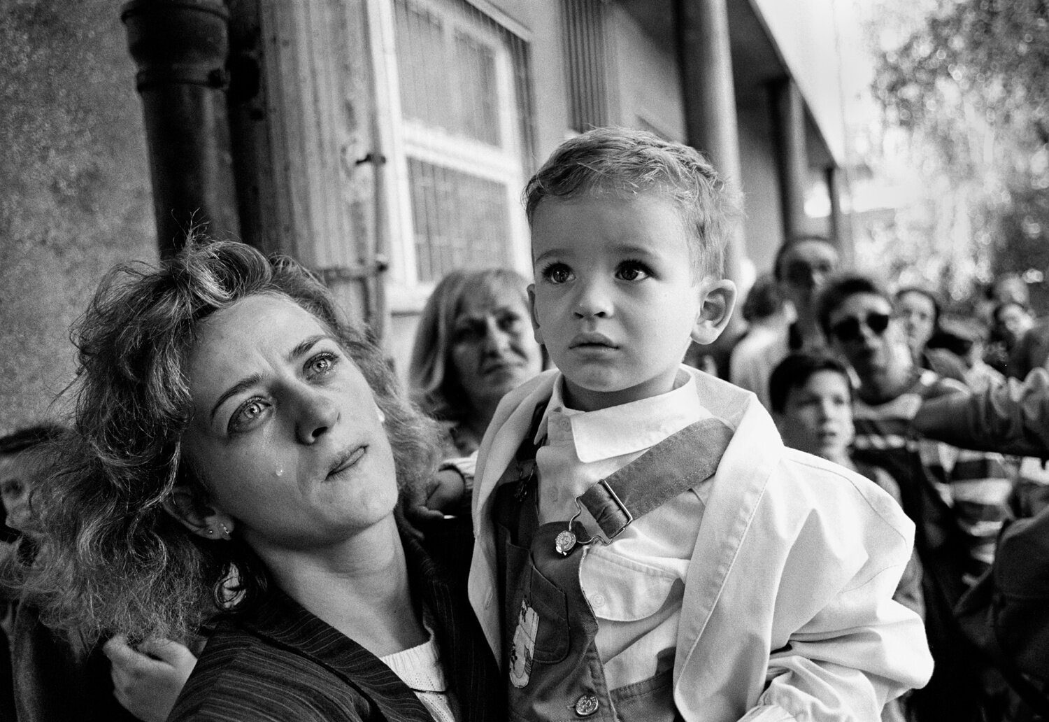 Tears of anguish for a mother as she prepares to send her confused child out of Sarajevo on a bus promised safe passage by the Serb forces during the siege in 1992. After the war the woman was identified as Gordana Burazor holding her baby son Andre. They left Sarajevo and the war behind and were given refugee status by Australia. (Photo by Tom Stoddart/Reportage by Getty Images)