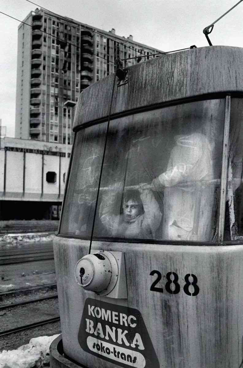Sarajevo, 1994. A small boy stares out of a tram car as it passes burnt out apartments and houses in Sarajevo. During the 47 months between the spring of 1992 and February 1996, the people of Sarajevo endured the longest siege Europe has witnessed since the end of the second world war. (Photo By Tom Stoddart/Getty Images)
