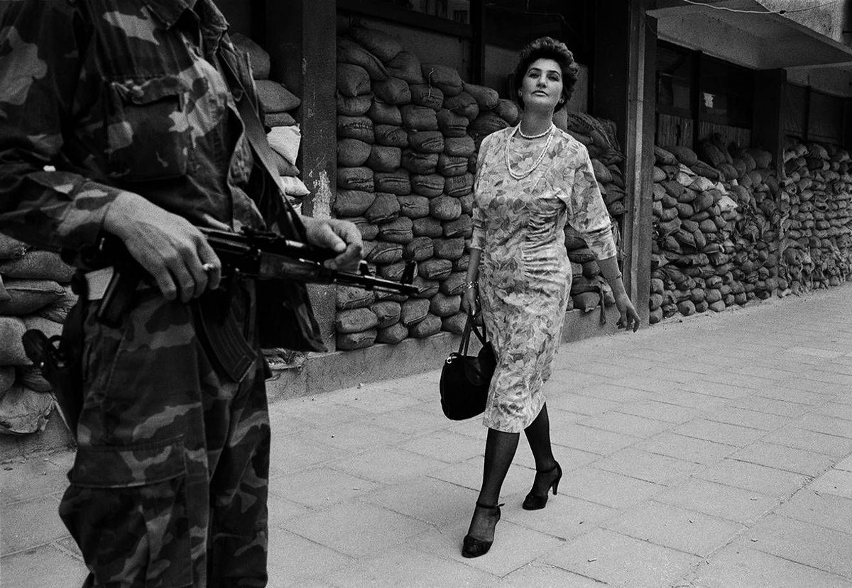 Sarajevo, 1993. In the dangerous suburb of Dobrinja Meliha Vareshanovic walks proudly and defiantly to work during the siege of Sarajevo. Her message to the watching gunmen who surround her city is simple, "you will never defeat us." (Photo By Tom Stoddart/Getty Images)