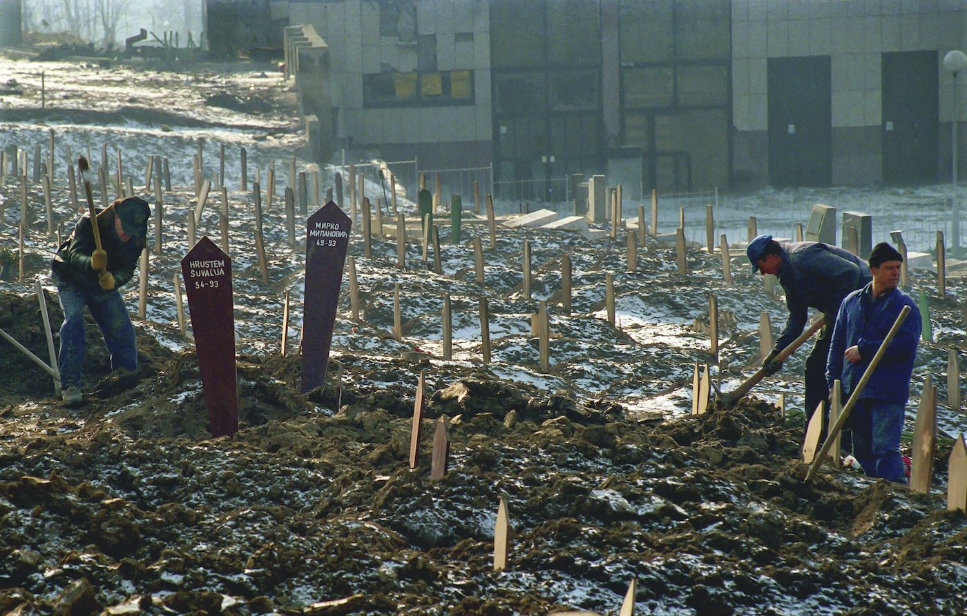 Gravediggers find room in the sporting grounds adjacent to the Lion cemetery in the capital Sarajevo, 1993.